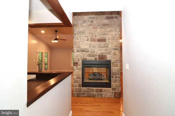 an empty room with a fireplace and fan