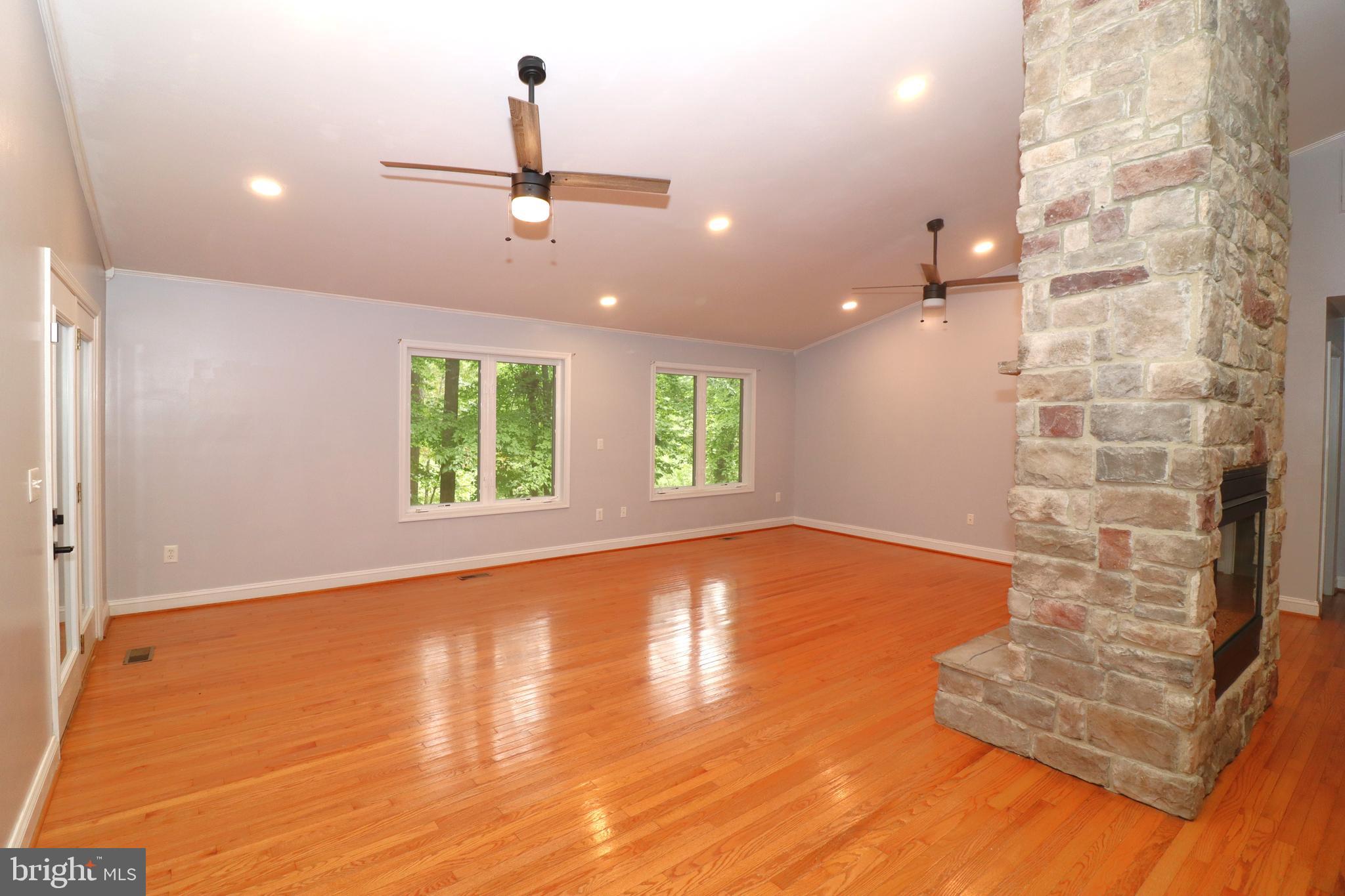 1111 Eastover Parkway Locust Grove, VA 22508 - Photo 6 of 62 an empty room with windows and ceiling fan