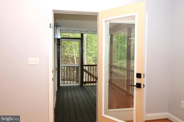 a view of front door with wooden floor