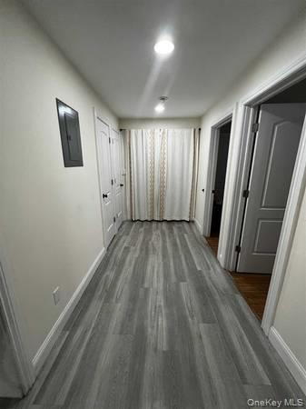 1029 Beekman Road, Unit 4 Hopewell Junction, NY 12533 - Photo 2 of 9 an empty room with wooden floor and sliding door