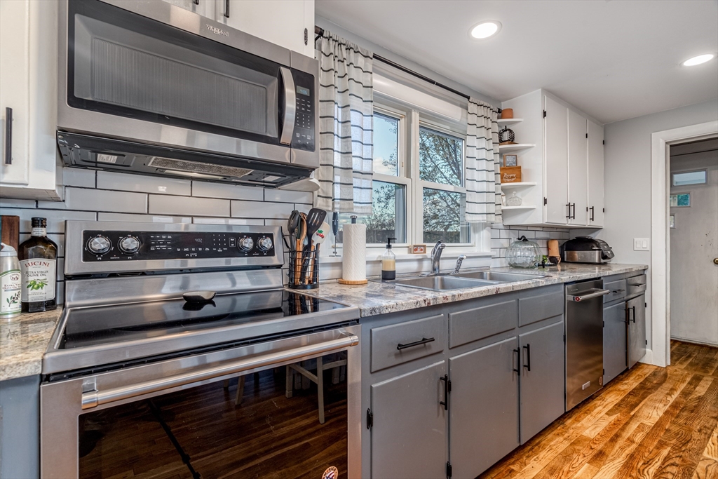 319 Chase Road Lunenburg, MA 01462 - Photo 13 of 26 a kitchen with stainless steel appliances granite countertop a stove microwave and sink