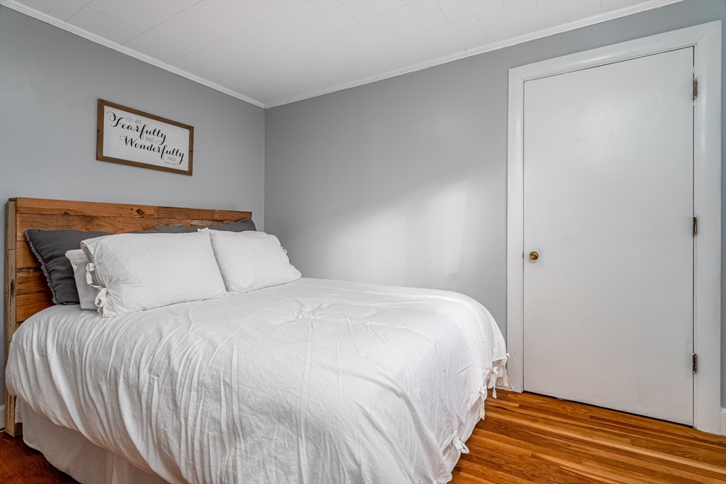 319 Chase Road Lunenburg, MA 01462 - Photo 16 of 26 a bedroom with a bed and painting on the wall