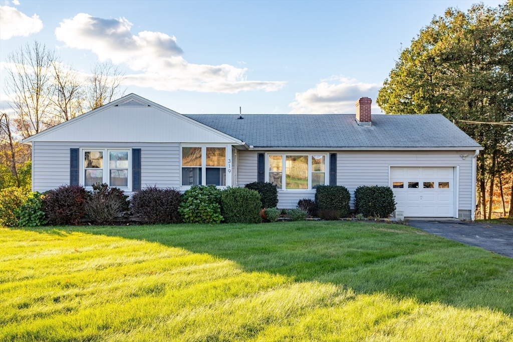 319 Chase Road Lunenburg, MA 01462 - Photo 2 of 26 a front view of a house with garden and yard