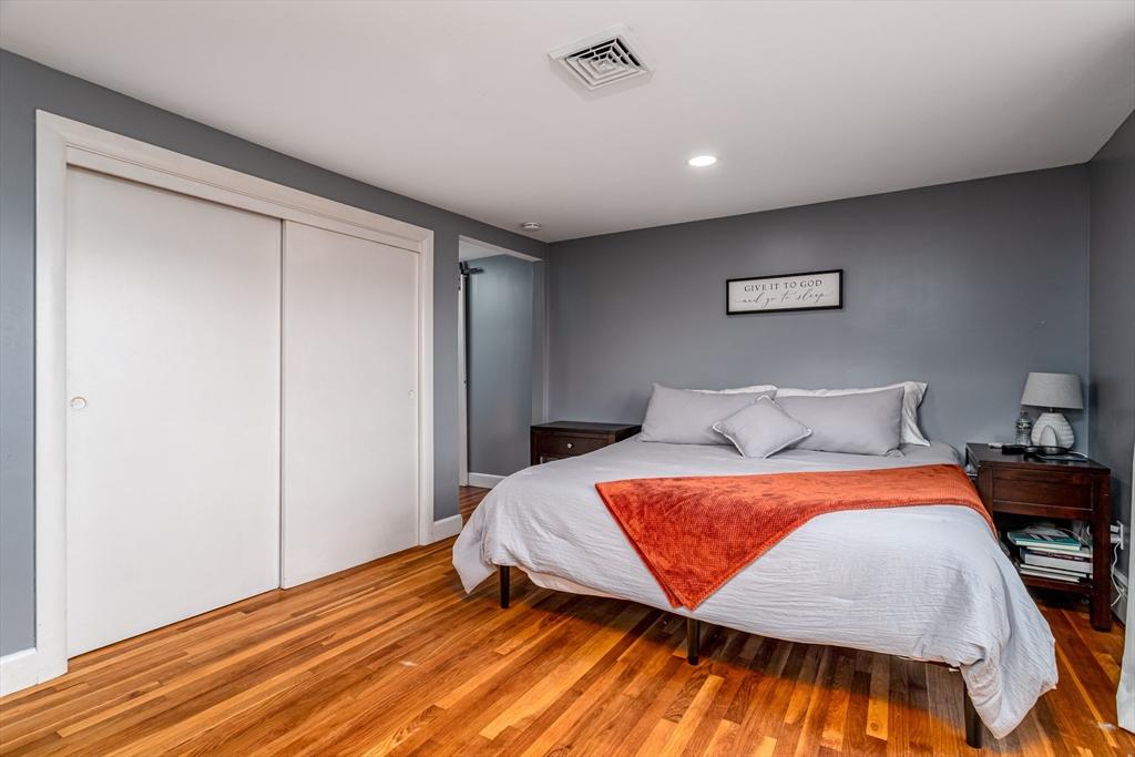 319 Chase Road Lunenburg, MA 01462 - Photo 21 of 26 a bedroom with a bed and a painting on the wall