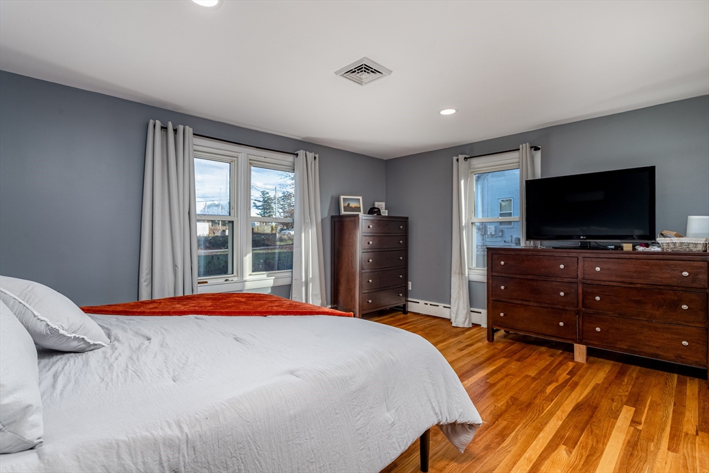 319 Chase Road Lunenburg, MA 01462 - Photo 22 of 26 a bedroom with a bed and a flat screen tv