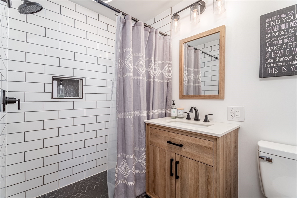 319 Chase Road Lunenburg, MA 01462 - Photo 24 of 26 a bathroom with a sink a toilet and shower