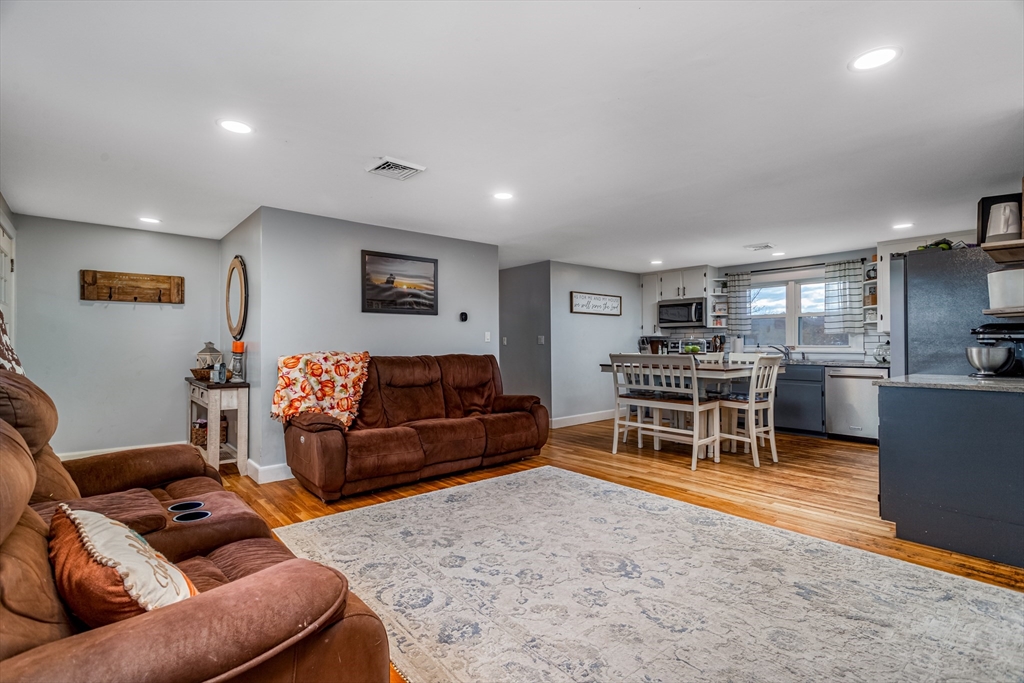 319 Chase Road Lunenburg, MA 01462 - Photo 9 of 26 a living room with furniture and kitchen view