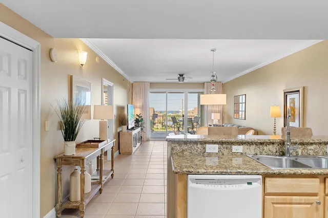 a kitchen with counter top space and living room
