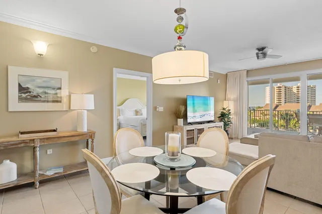 a view of a dining room with furniture and a chandelier