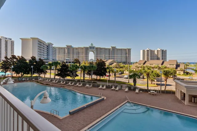 a view of a swimming pool with outdoor seating and city view
