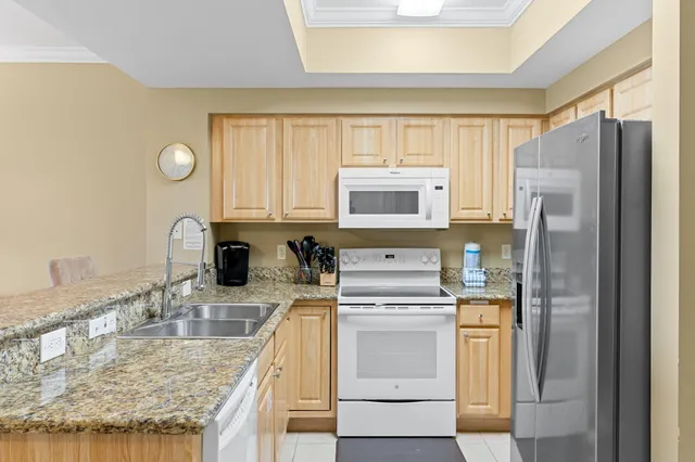 a kitchen with a sink a stove and refrigerator