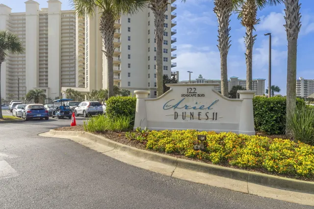 a front view of a residential apartment building with a yard
