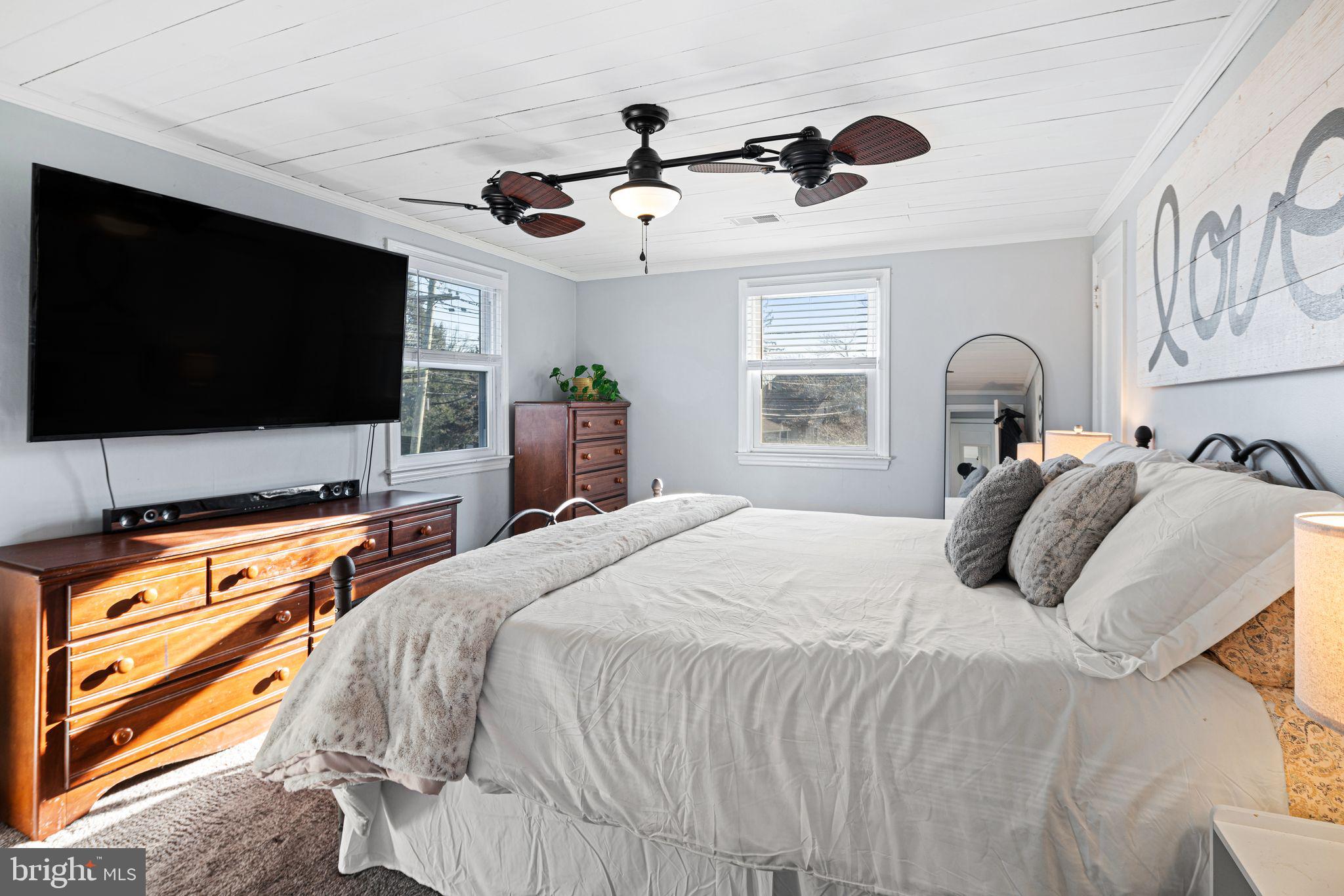 273 Hopkins Road Haddonfield, NJ 08033 - Photo 20 of 35 a bedroom with a bed and a flat screen tv