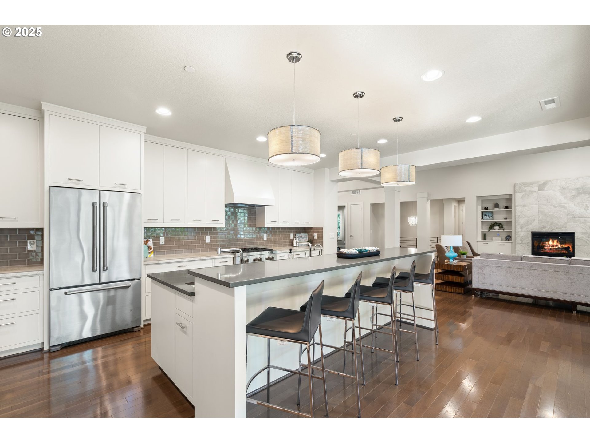 3425 Southwest 57th Avenue Portland, OR 97221 - Photo 12 of 33 a kitchen with stainless steel appliances a stove a refrigerator a kitchen island with white cabinets and wooden floor