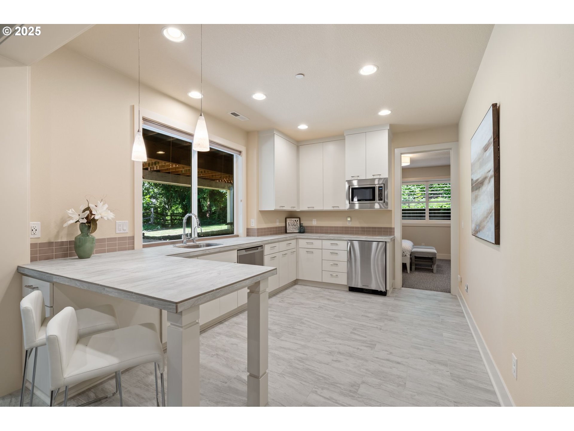 3425 Southwest 57th Avenue Portland, OR 97221 - Photo 22 of 33 a kitchen with stainless steel appliances granite countertop a sink counter space and a refrigerator