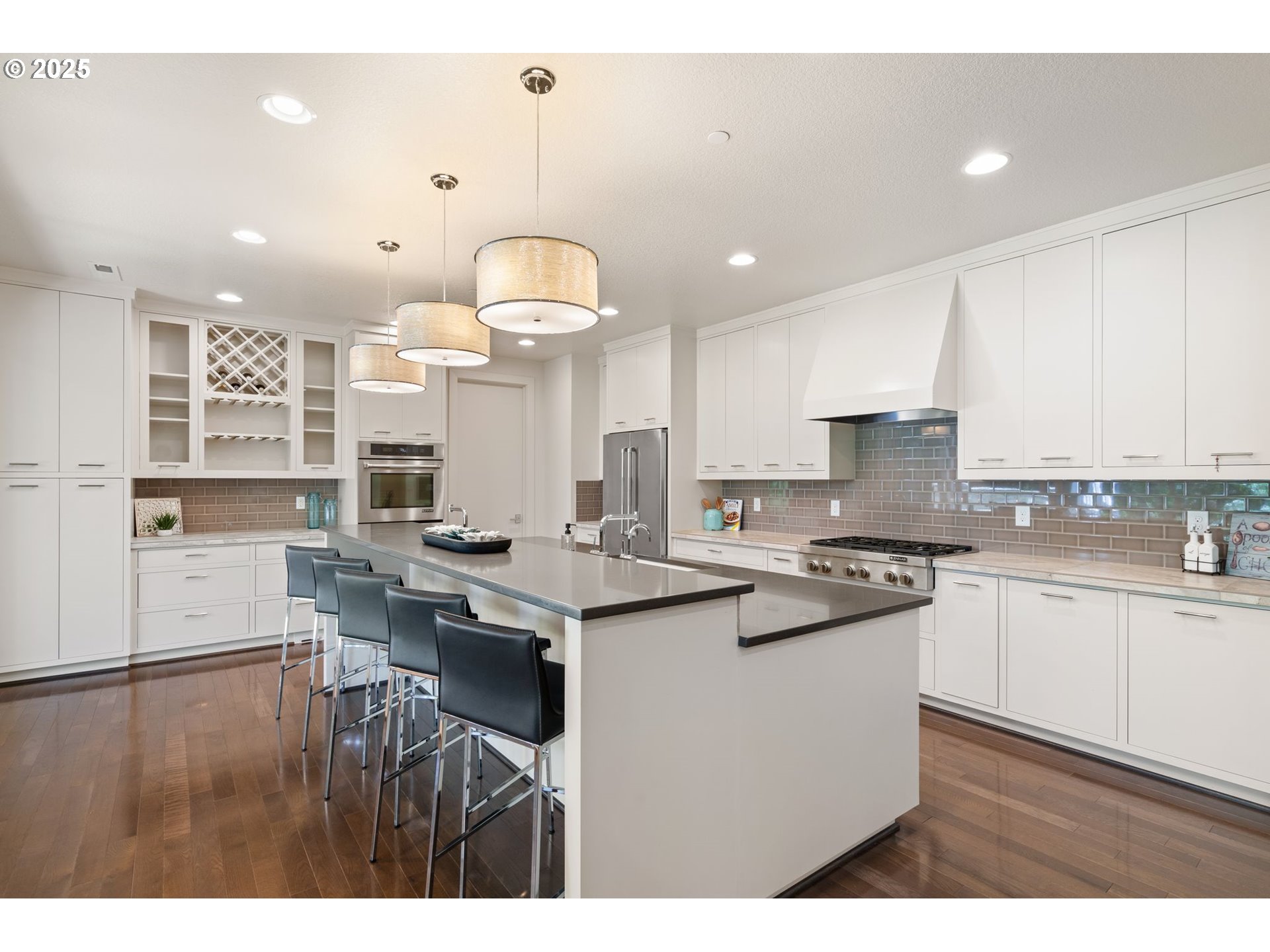 3425 Southwest 57th Avenue Portland, OR 97221 - Photo 6 of 33 a kitchen with stainless steel appliances granite countertop a sink a stove a refrigerator and white cabinets