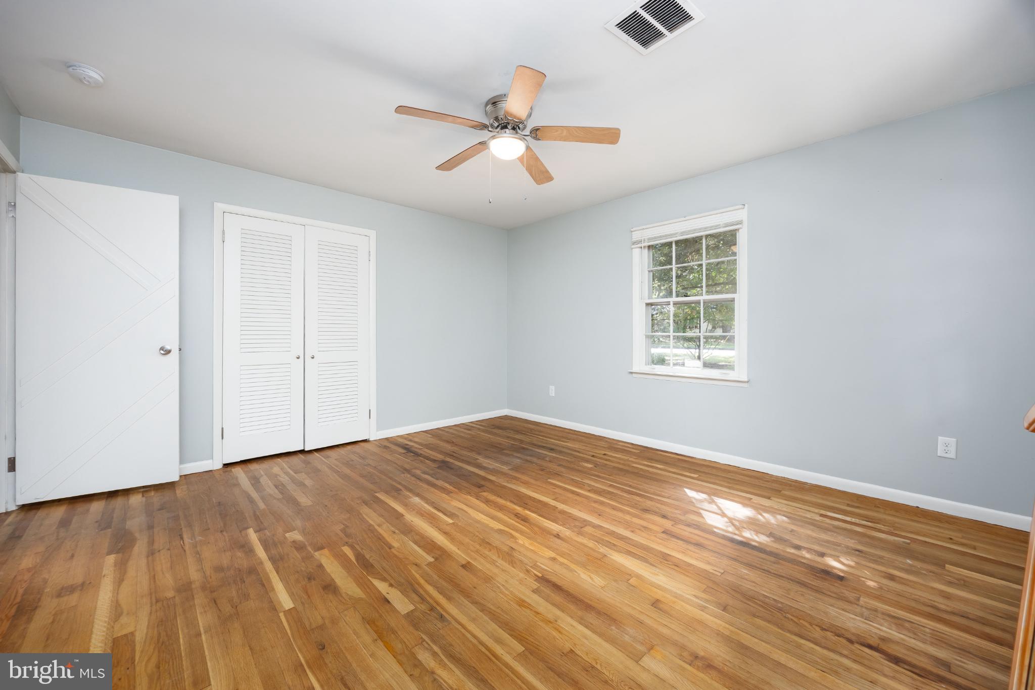 1105 Middleneck Drive Salisbury, MD 21804 - Photo 19 of 38 a view of an empty room with wooden floor and a window