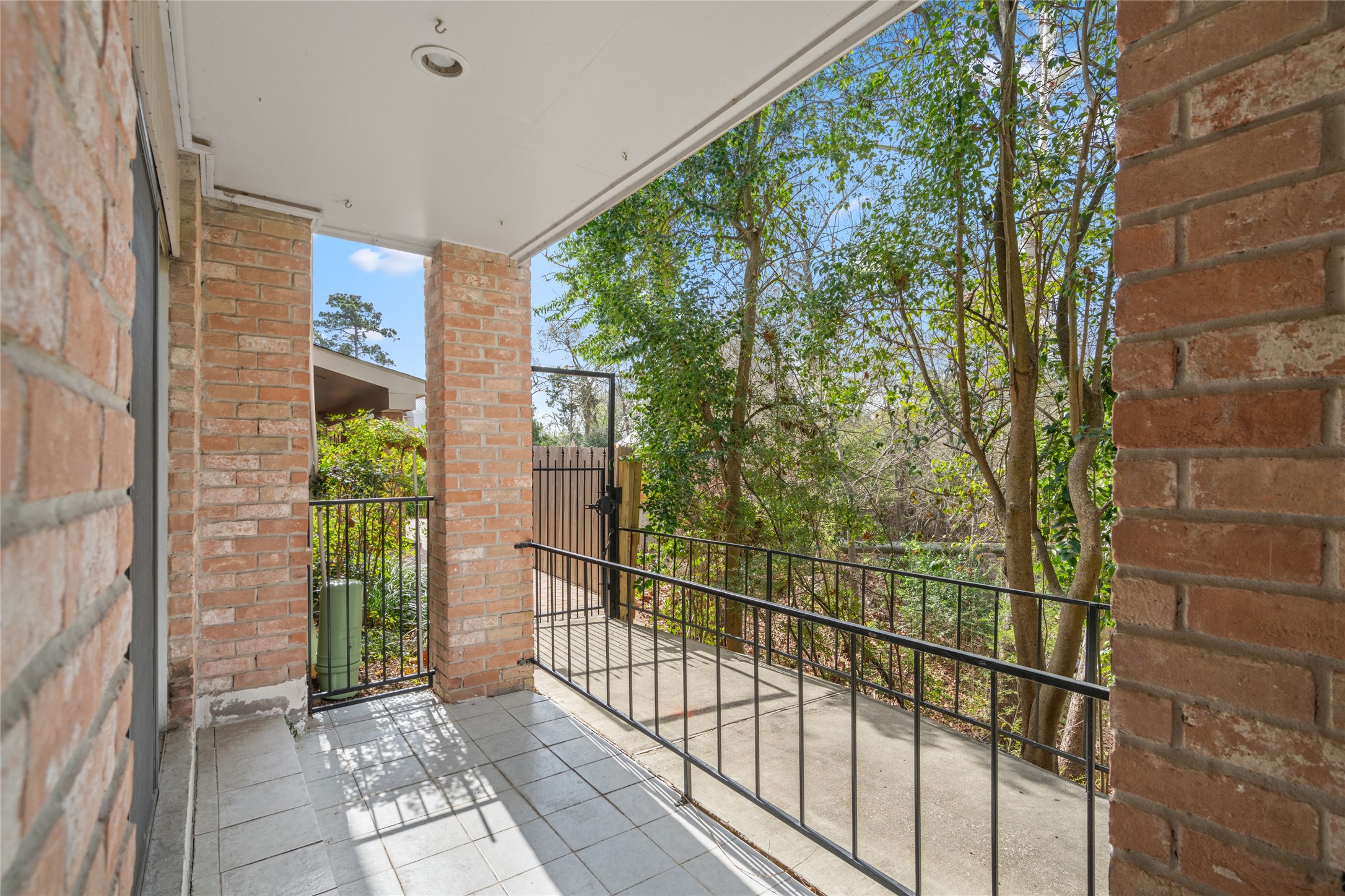 2238 South Piney Point Road, Unit 102 Houston, TX 77063 - Photo 13 of 34 PATIO 1: Arrive at this back patio, which overlooks the bayou greenery, from the sliding doors of the living room.