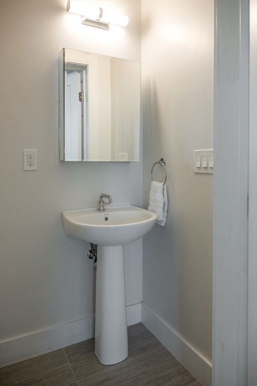 24 Rush Street, Unit I Somerville, MA 02145 - Photo 12 of 21 a bathroom with a sink and mirror