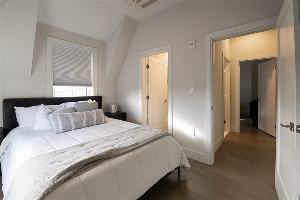 24 Rush Street, Unit I Somerville, MA 02145 - Photo 15 of 21 a bedroom with a bed and wooden floor