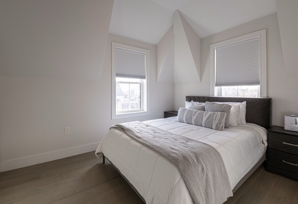 24 Rush Street, Unit I Somerville, MA 02145 - Photo 16 of 21 a bedroom with a bed and a window