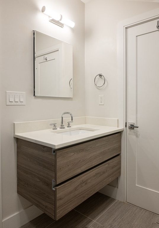 24 Rush Street, Unit I Somerville, MA 02145 - Photo 19 of 21 a bathroom with a sink vanity and a mirror