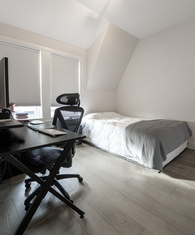 24 Rush Street, Unit I Somerville, MA 02145 - Photo 20 of 21 a bedroom with a bed and a desk