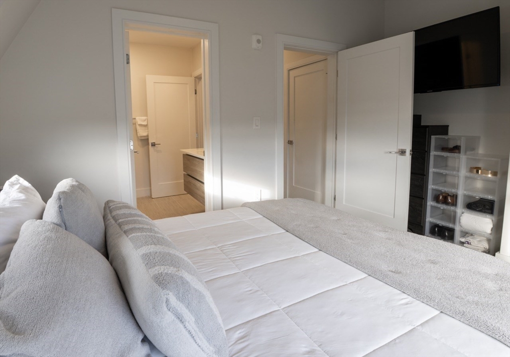 24 Rush Street, Unit I Somerville, MA 02145 - Photo 21 of 21 a bedroom with a bed and a television in it