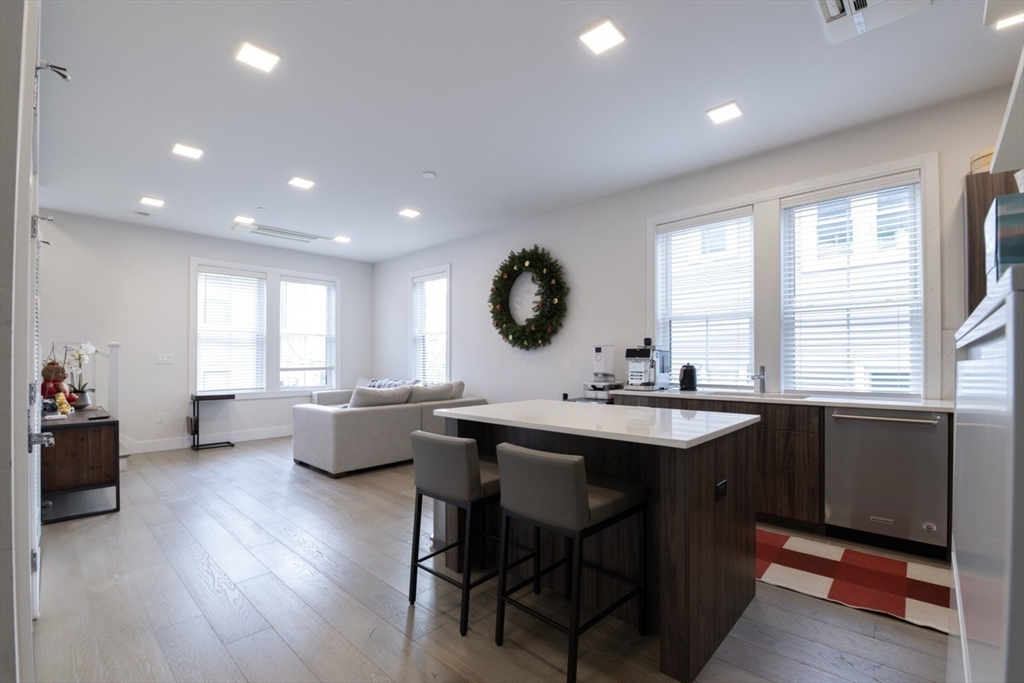 24 Rush Street, Unit I Somerville, MA 02145 - Photo 4 of 21 a view of a dining room with furniture window and wooden floor