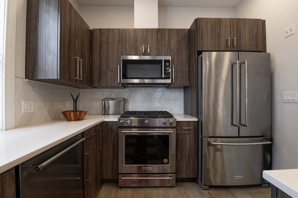 24 Rush Street, Unit I Somerville, MA 02145 - Photo 5 of 21 a kitchen with a stove microwave and refrigerator