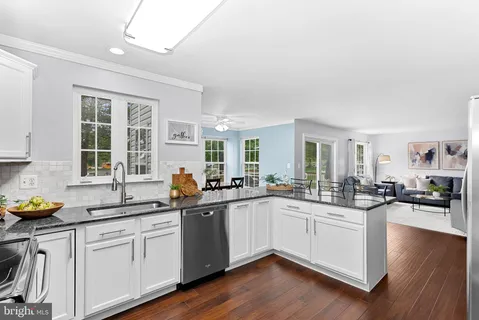 a kitchen with sink and cabinets