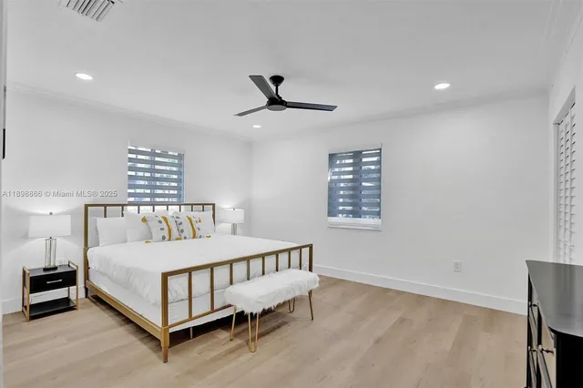 a bedroom with a bed and a ceiling fan