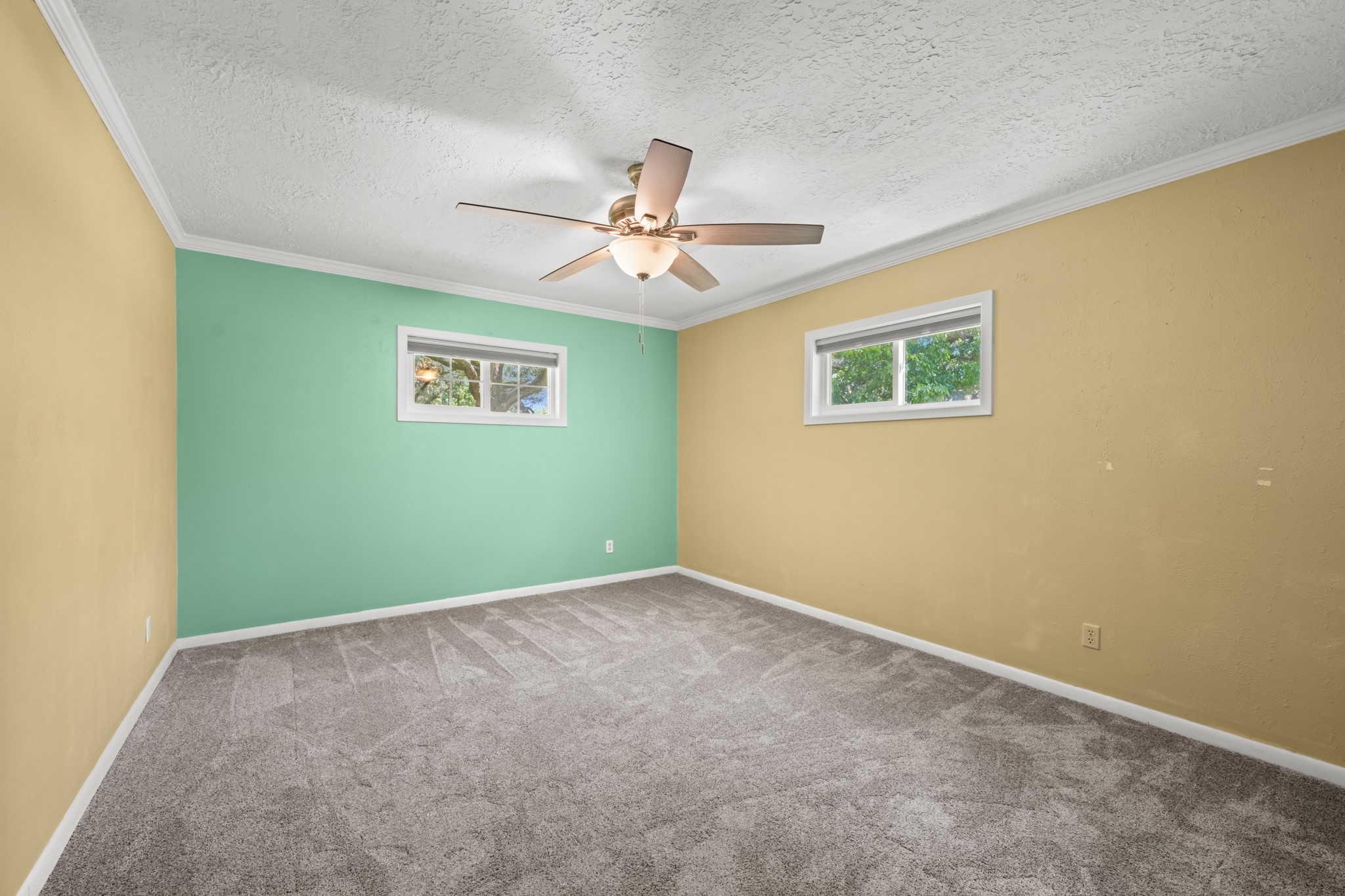 616 Cannan Drive Angleton, TX 77515 - Photo 24 of 49 This generously sized secondary bedroom features plush carpeting, a ceiling fan, and multiple windows that bring in natural light. The spacious layout offers flexibility for family members, guests, or a home office while providing a comfortable and inviting retreat.