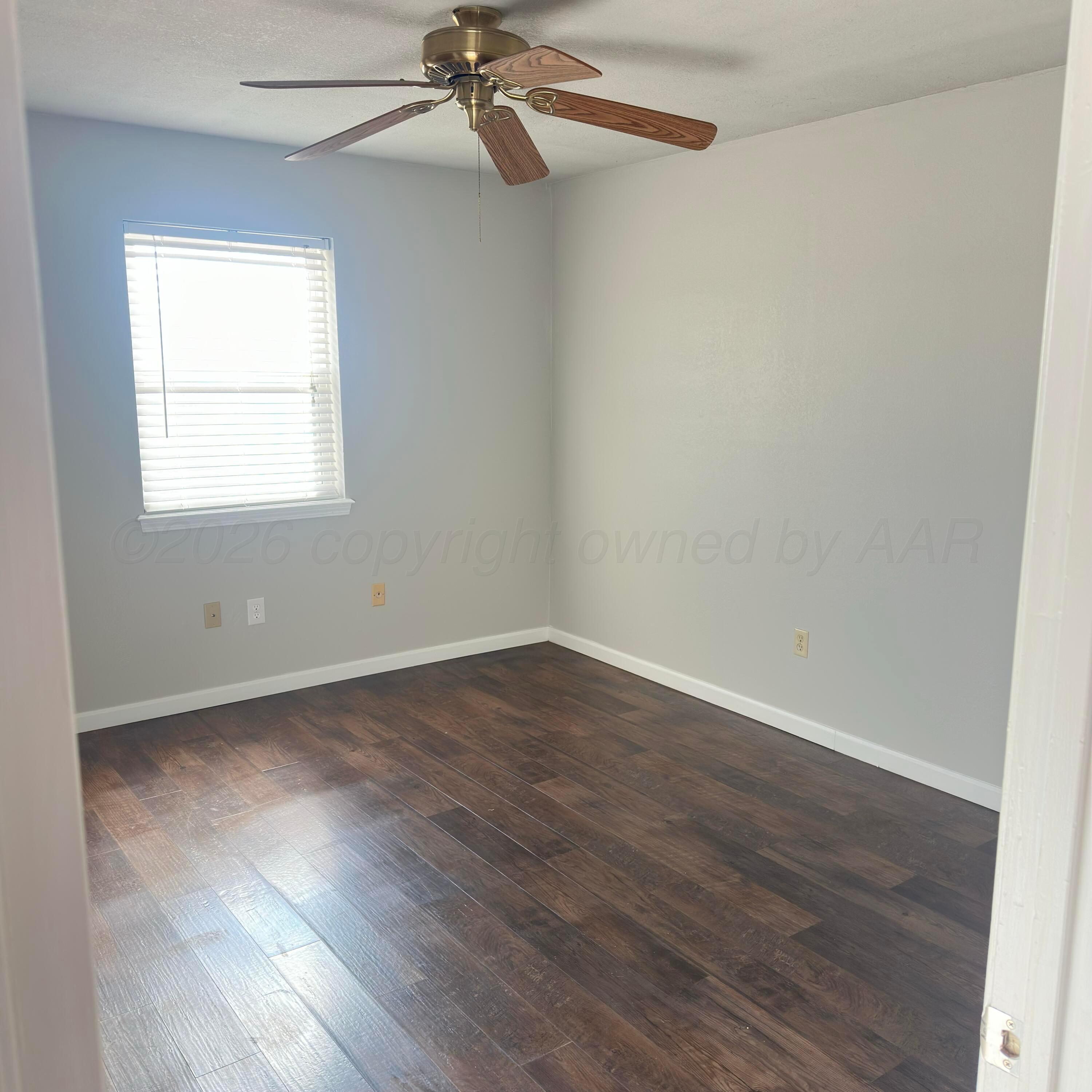 805 Oregon Trail Canyon, TX 79015 - Photo 13 of 14 wooden floor in an empty room with a window