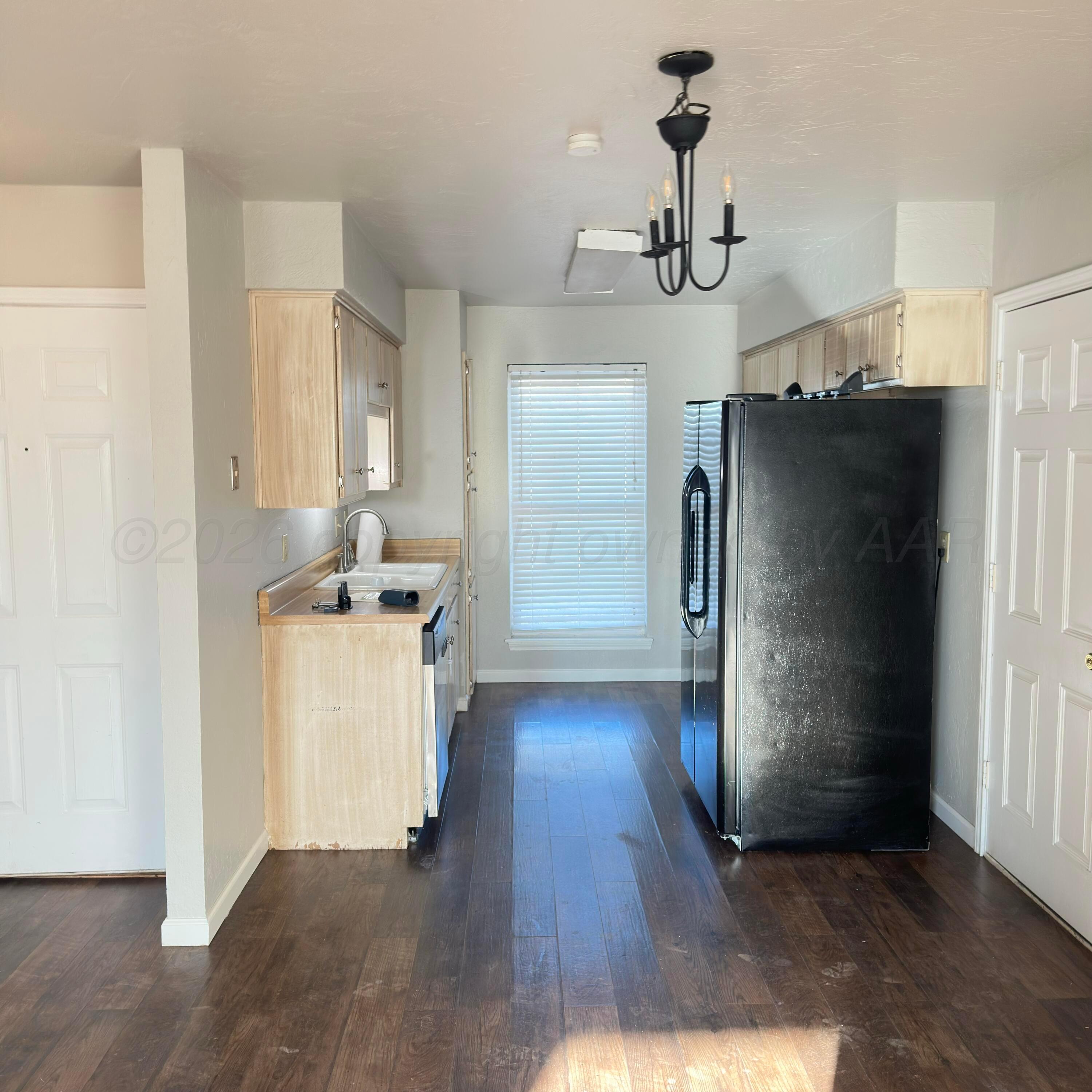 805 Oregon Trail Canyon, TX 79015 - Photo 4 of 14 a view of a kitchen with refrigerator and wooden floor