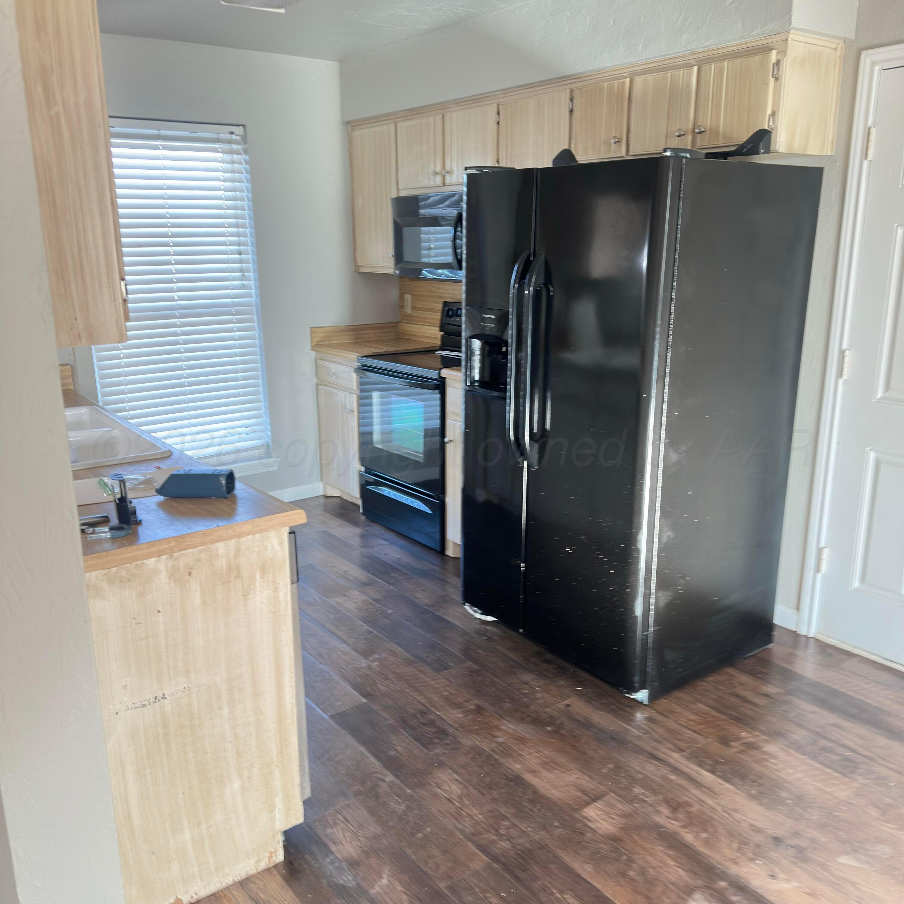 805 Oregon Trail Canyon, TX 79015 - Photo 6 of 14 a kitchen with stainless steel appliances a refrigerator and a sink