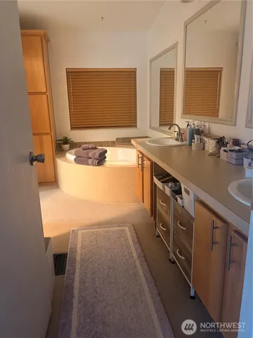 a bathroom with a sink a mirror and a bathtub