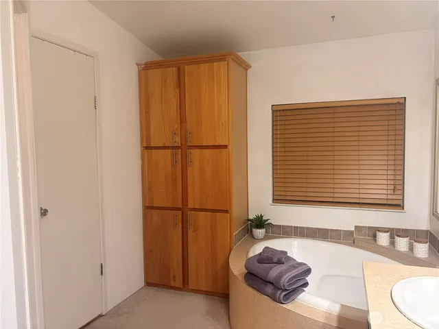 a bathroom with a tub and a sink