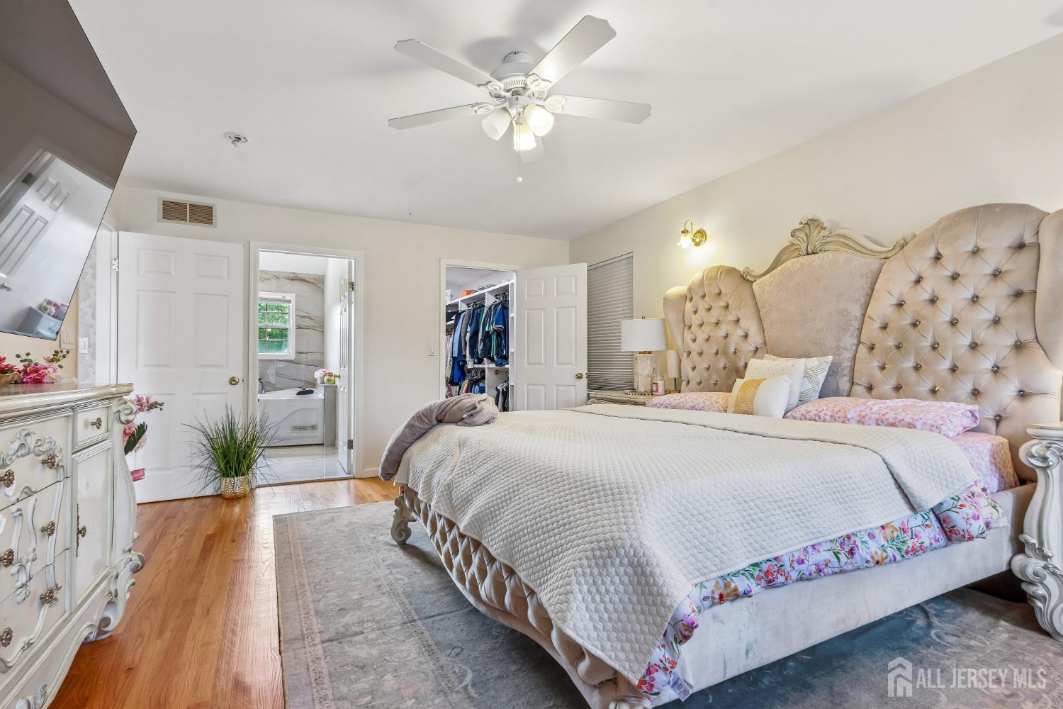 489 Plainfield Road Edison, NJ 08820 - Photo 23 of 39 a bedroom with bed and a chandelier