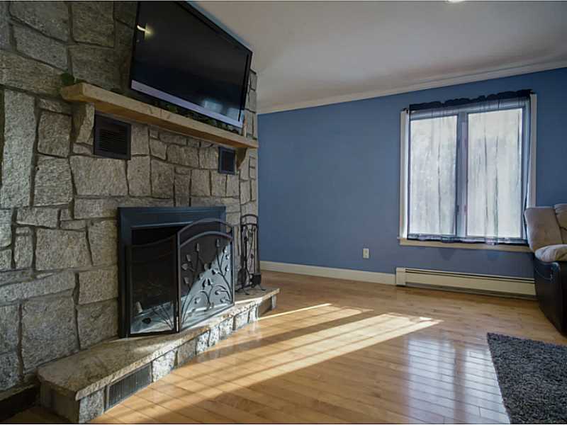 48 Maxson Hill Road Hopkinton, RI 02804 - Photo 9 of 18 Living Room. Beautiful stone fireplace accents both the living room and kitchen