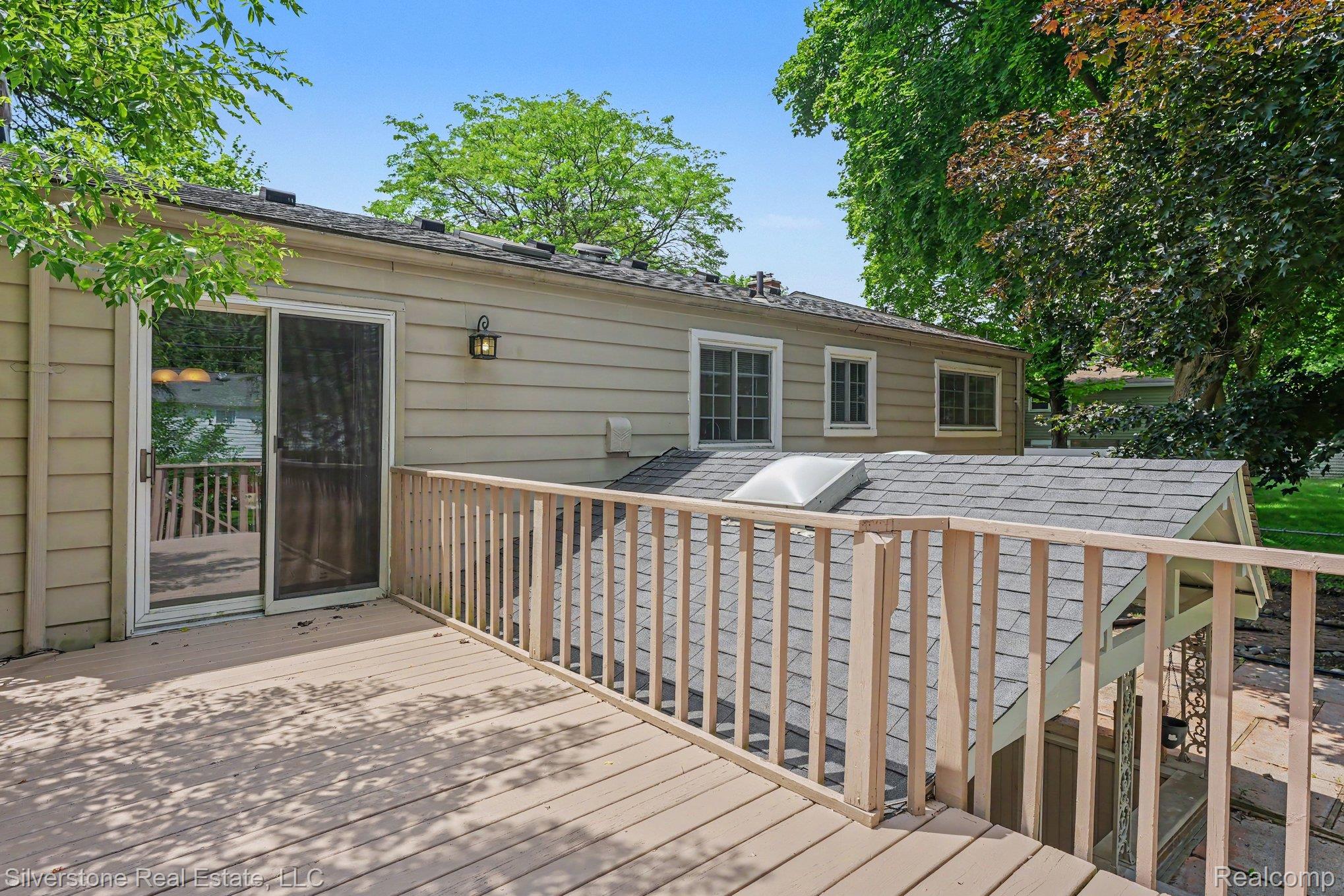 547 Reed Street Northville, MI 48167 - Photo 34 of 38 Spacious wood-finish deck with a wood railing and a sliding glass door