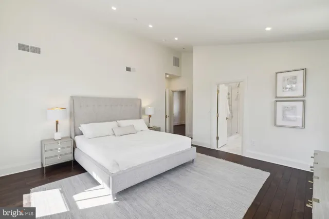 a bedroom with a bed and a night stand