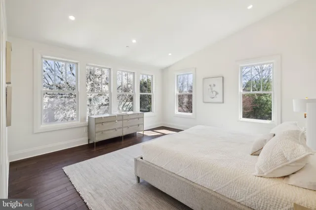 a spacious bedroom with a bed and a large window