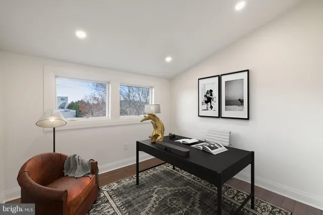 a living room with furniture potted plant and a window