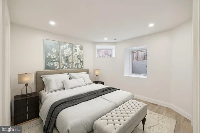 a bedroom with a bed and a lamp with window