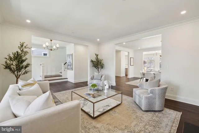 a living room with furniture and a large mirror