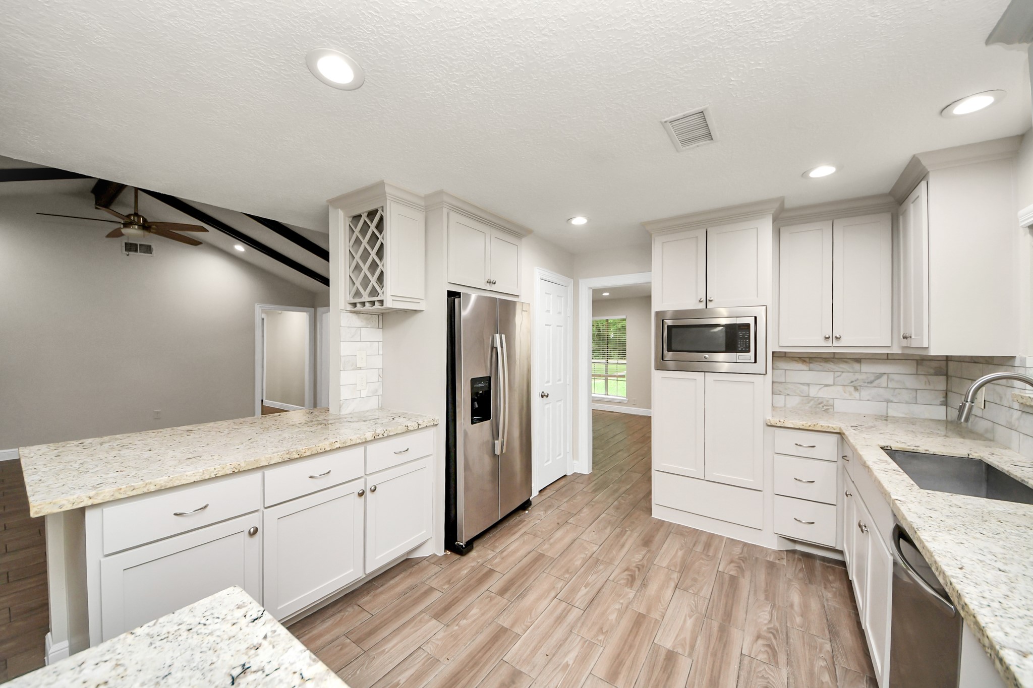 19435 Interstate 45 Spring, TX 77388 - Photo 12 of 24 a kitchen with a sink a refrigerator and cabinets