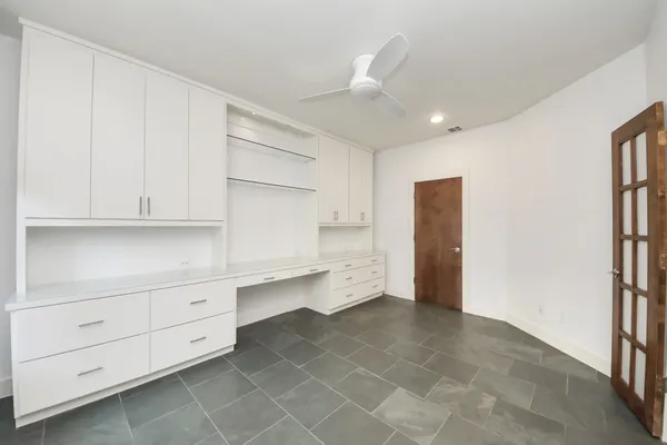 a room with a white wall storage and utility