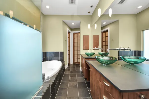 a bathroom with a double vanity sink toilet and a mirror