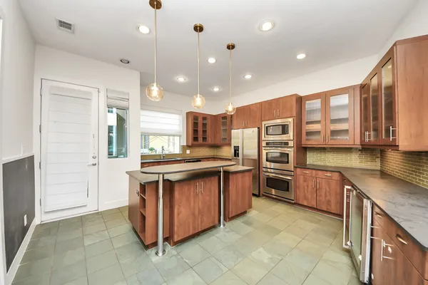 a kitchen with stainless steel appliances granite countertop a stove and cabinets